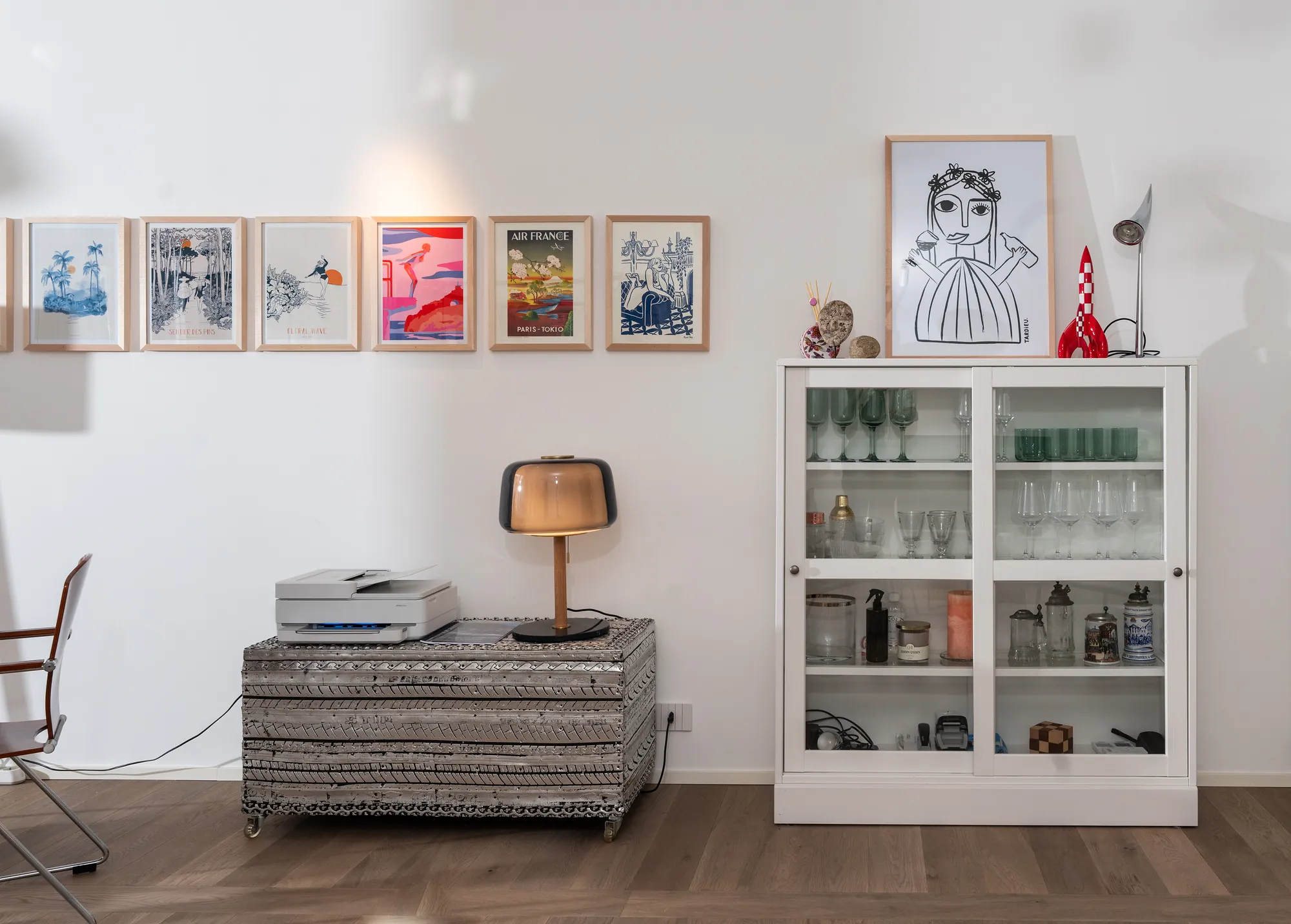 Workstation corner in the garden apartment with printer, glass cabinet and framed prints