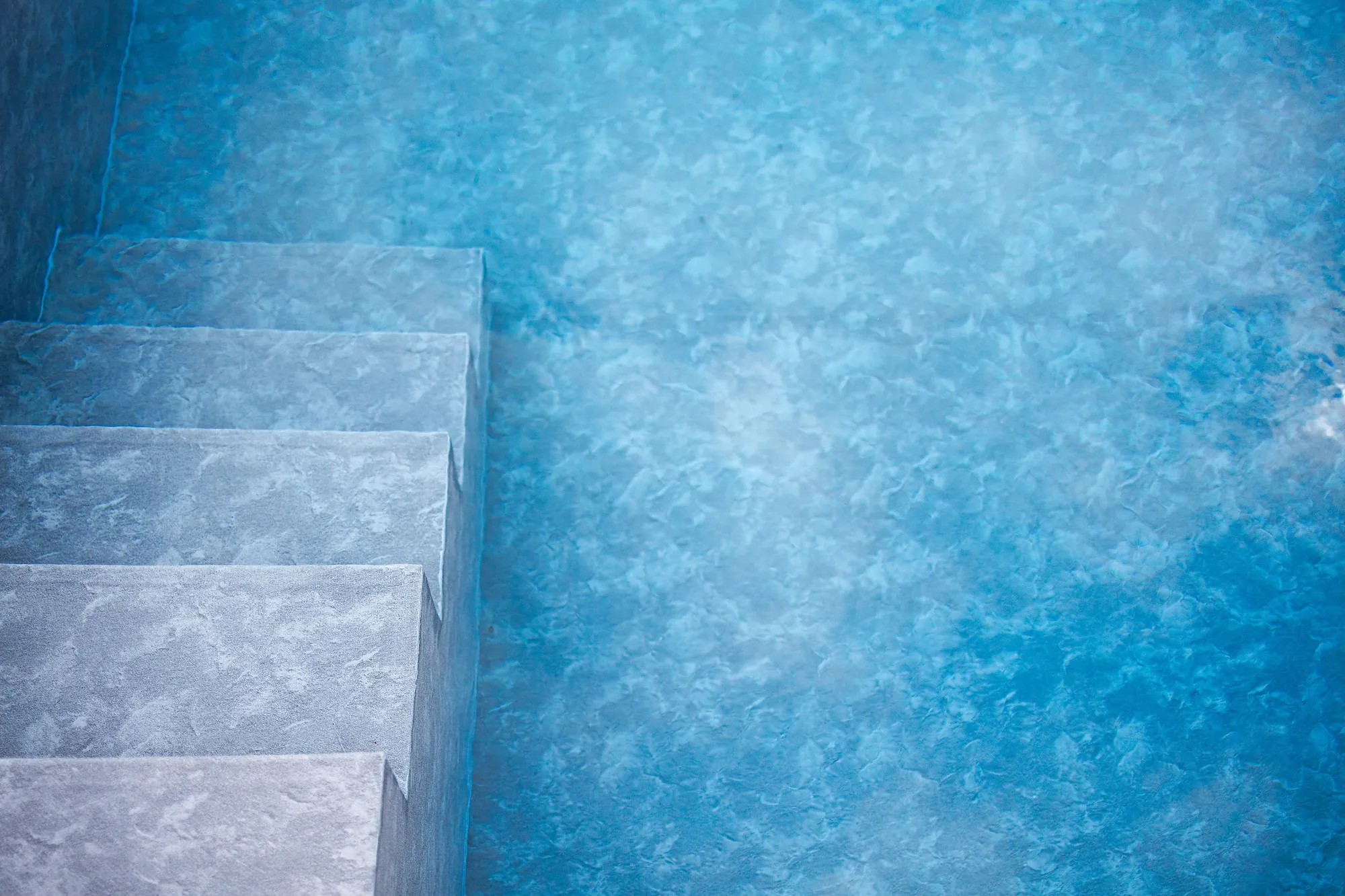 Close-up of the turquoise water and steps of the saltwater pool